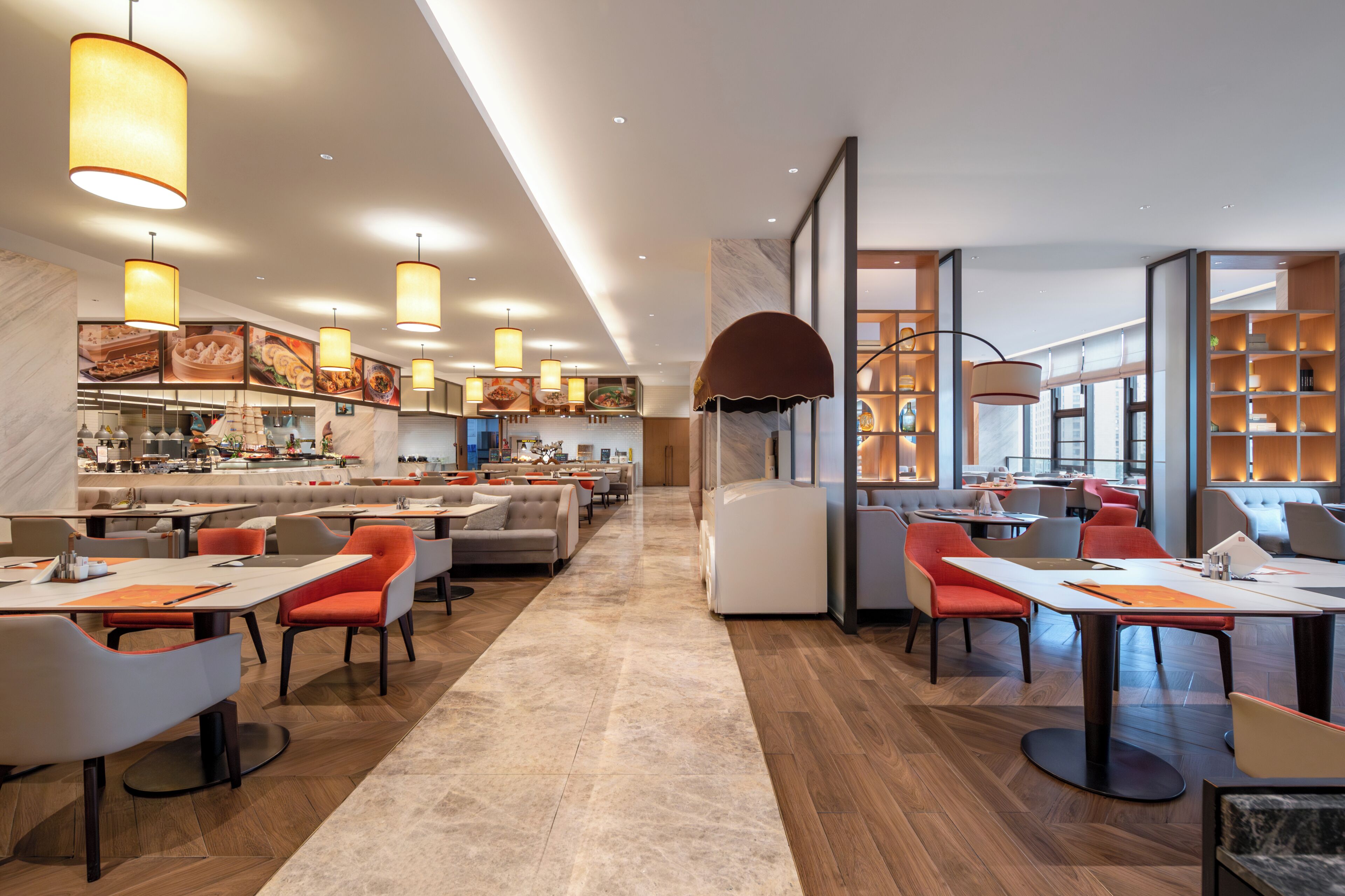 A modern dining area with high tables, chairs, and pendant lighting.