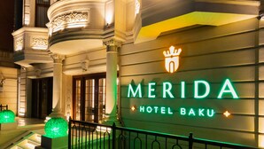 A hotel entrance with a sign reading "MERIDA HOTEL BAKU," featuring ornate architectural details and a well-lit facade. - Merida Hotel Baku (Baku)