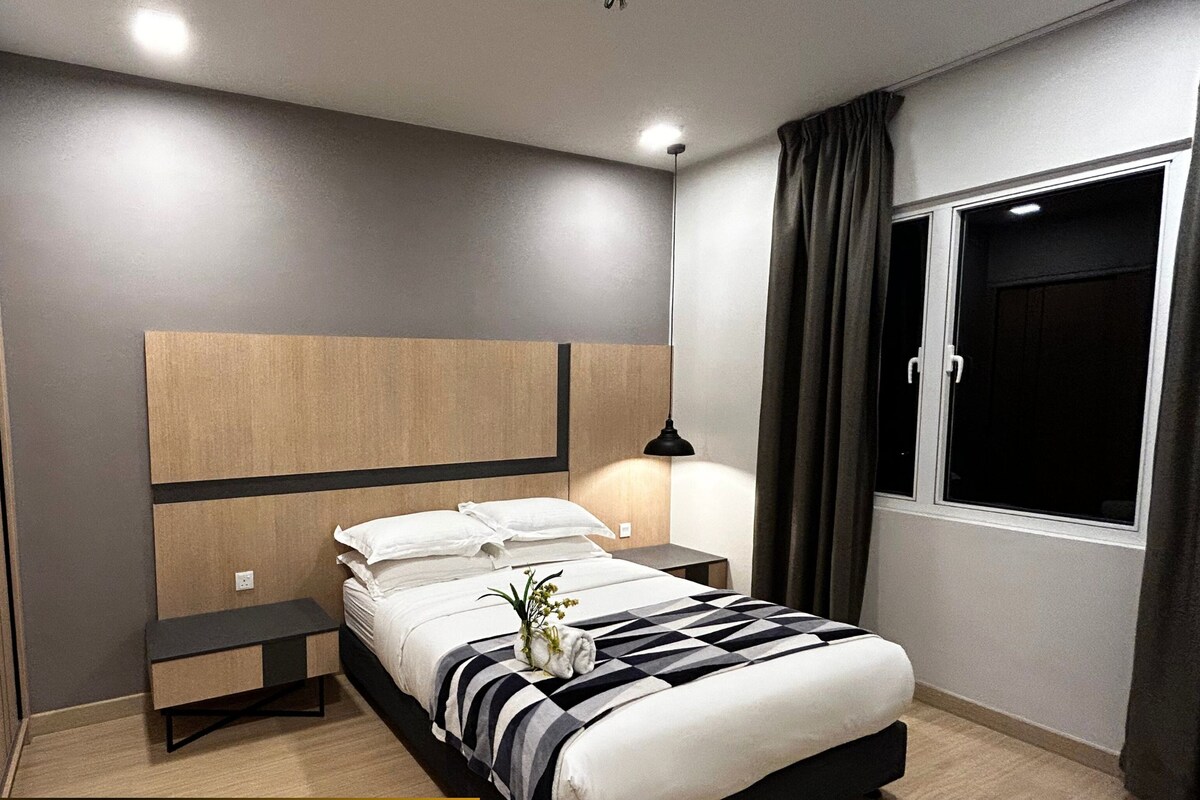 A 2-bedroom premier king suite with a balcony, featuring a modern design with a large bed, bedside tables, and a nightstand.