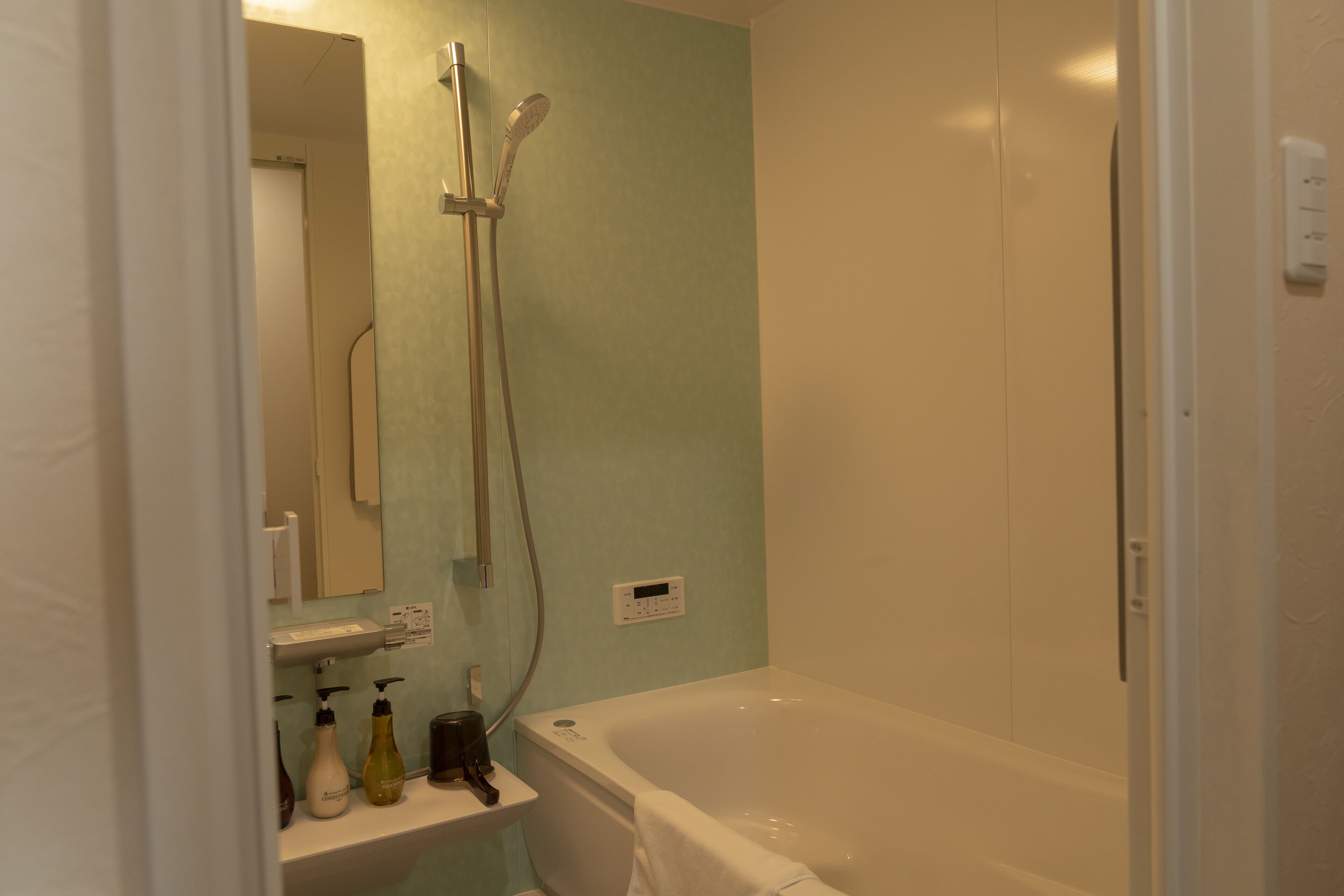 Ein Badezimmer mit Badewanne, Dusche und Spiegel.
