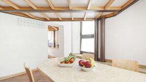 A dining area with a table set for two, featuring a fruit bowl and a vegetable dish. - Inviting 3-bed Apartment in Roma 4mins to Colosseo (Rome)