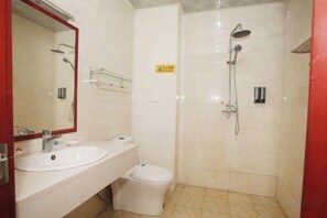 A bathroom with a sink, toilet, and shower. - Wuhu Holiday Hotel (Linze)