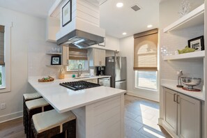 Enjoy cooking and entertaining in this well-equipped kitchen with a central island, gas stove, and appliances.
