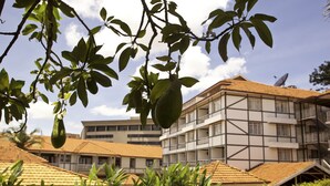 A building with a traditional architectural style, featuring a mix of white and dark-colored panels. - Mosa Court Apartments (Kampala)