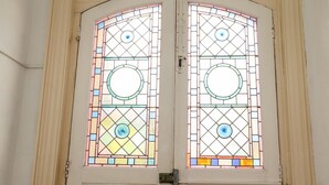 A double door with stained glass panels. - Magpies (St Leonards-On-Sea)