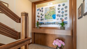 A wooden reception desk with a map and framed pictures of landmarks.