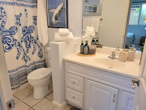 A bathroom with a toilet, a sink with toiletries, and a towel rack. - Exquisite Direct Sunset & Oceanview 4 Miles! Pool (Lahaina)