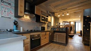A kitchen with wooden cabinets, a microwave, and a stove.