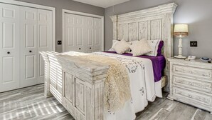 A bedroom with a bed, dresser, and wardrobe. - Georgia's Nature Retreat on Old Mill Pond (Statesboro)