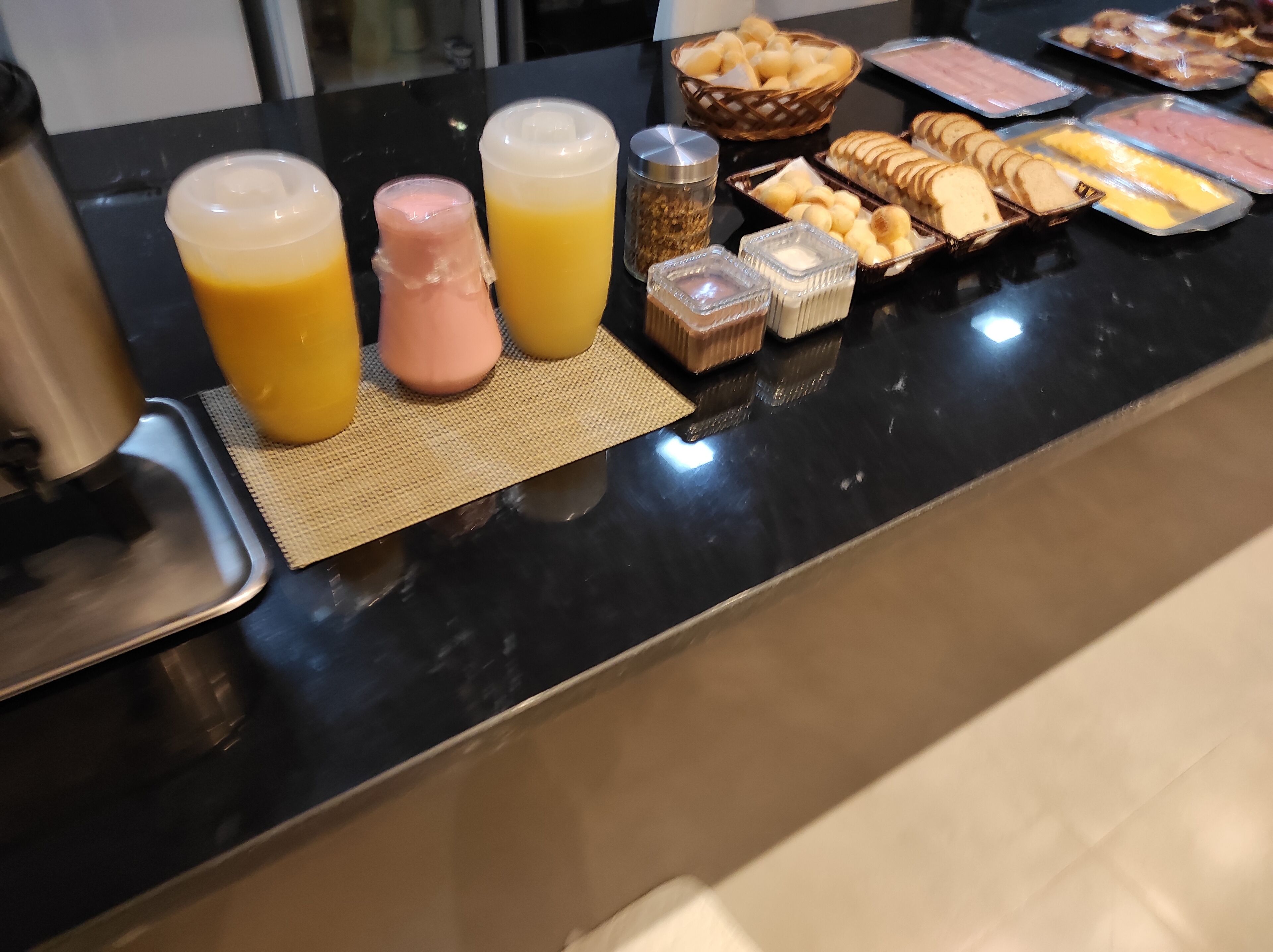 A breakfast buffet with various food items and beverages.