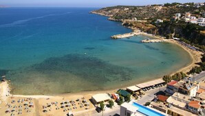 A coastal town with a beach, clear waters, and buildings along the shore. - Villa Metapothia in Gavalohori (Apokoronas)