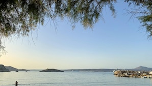 A beach with calm waters, a distant island, and a rocky outcrop. - Villa Zara in Plaka With 3 Bedrooms and 3 Bathrooms (Apokoronas)