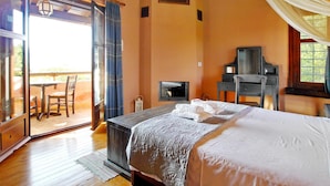 A bedroom with a bed, a piano, a television, and a sliding glass door leading to an outdoor area.