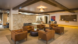 A spacious living area with leather sofas and a stone accent wall. - Modern and Updated St James Premium 3 Bedroom Residence 3 Condo by RedAwning (Avon)