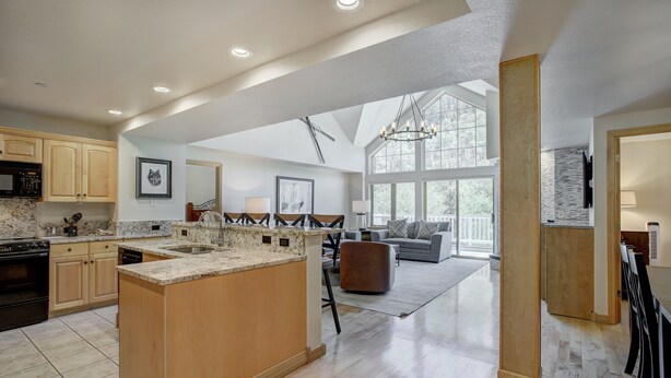 A spacious kitchen with a large island, wooden cabinets, and a built-in microwave. - Luxury 4 bedroom Premier Residence at St James Place 4 Condo by RedAwning (Avon)