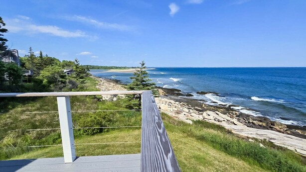 A coastal view with a wooden deck, rocky shoreline, and ocean waves. - Your Tranquil Indian Point Retreat with Breathtaking Views & Beach Access (Georgetown)