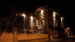 Un bâtiment à deux étages doté d’un balcon et d’une fenêtre circulaire.