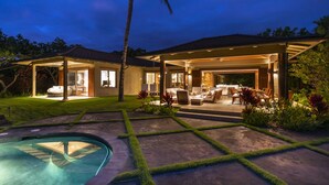 A modern house with a pool, outdoor seating area, and a covered patio. - Elevated 4BR Kahikole Estate 218 at Hualalai – Indoor-Outdoor Living & Views (Kailua Kona)