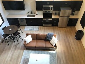 Cozy living space with a kitchenette, sofa, and dining area.