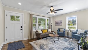 A living room with a ceiling fan, a sofa, a chair, a coffee table, and a rug. - 3BR Near Swamp Rabbit Trail • Fenced Yard • Pet-Friendly • 7 Min to Downtown (Greenville)