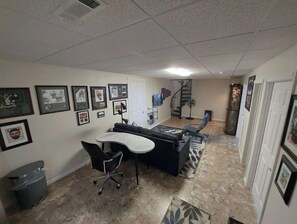 Relax in this inviting space with a desk, comfortable sofa, and framed artwork.