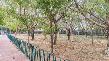 Un sendero bordeado de árboles y una valla de metal.