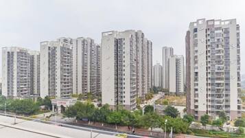 Un edificio residencial alto con varios pisos, balcones y un diseño de techo plano.