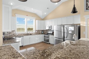 Enjoy cooking in this well-equipped kitchen with a refrigerator, microwave, and double oven.