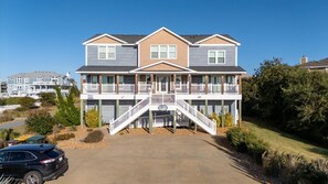Stroll up to the charming front porch, flanked by windows and a central entryway, and enjoy the serene surroundings.