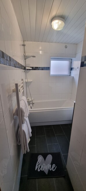 Separate bathtub and shower, designer toiletries, hair dryer, towels