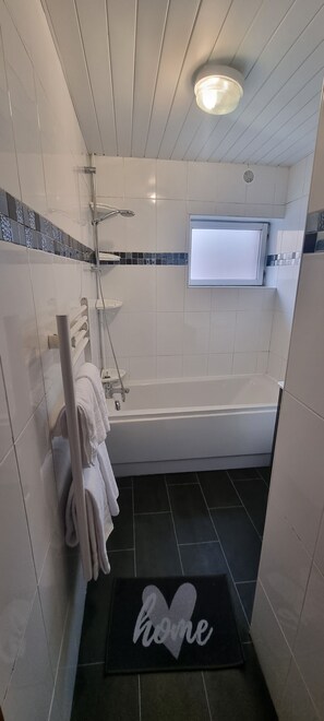 Separate tub and shower, designer toiletries, hair dryer, towels