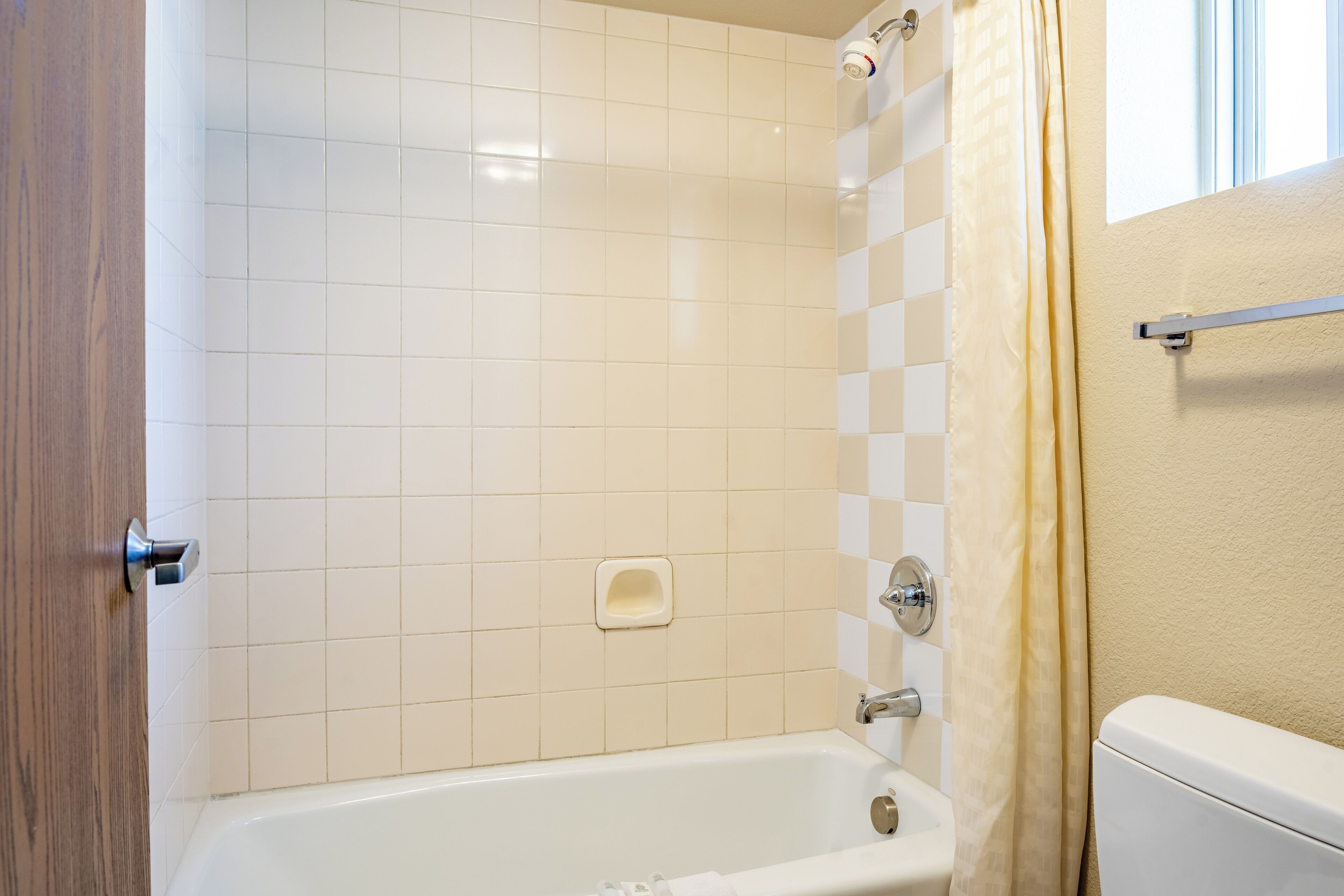 A bathroom with a bathtub, a shower, and a toilet.