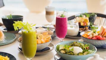A breakfast buffet with various dishes and drinks.