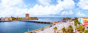 A coastal cityscape with a marina, colorful buildings, and a clear sky. - Harbor Hotel & Casino Curacao (Willemstad)