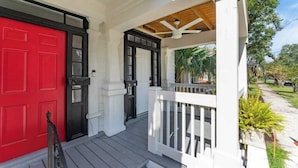 A porch with a red door and a white railing. - Cozy Springfield Abode - AC, Wifi, WD (Jacksonville)