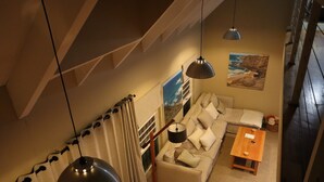Un salon moderne avec un canapé, une table basse en bois et un tableau représentant une scène de plage.