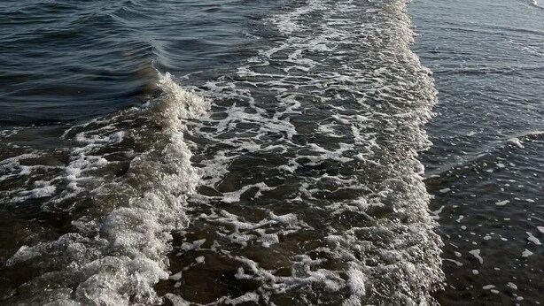 A beach with waves approaching the shore. - AJs Beach Haven - family fun- beautiful vacation home in Sea Isle (Galveston)