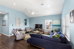 Smart TV, fireplace, books, computer monitors