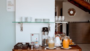 A breakfast bar with coffee makers, cups, plates, and a sign indicating entry is permitted for staff only. - Pousada Shalom Capitólio (Capitólio)