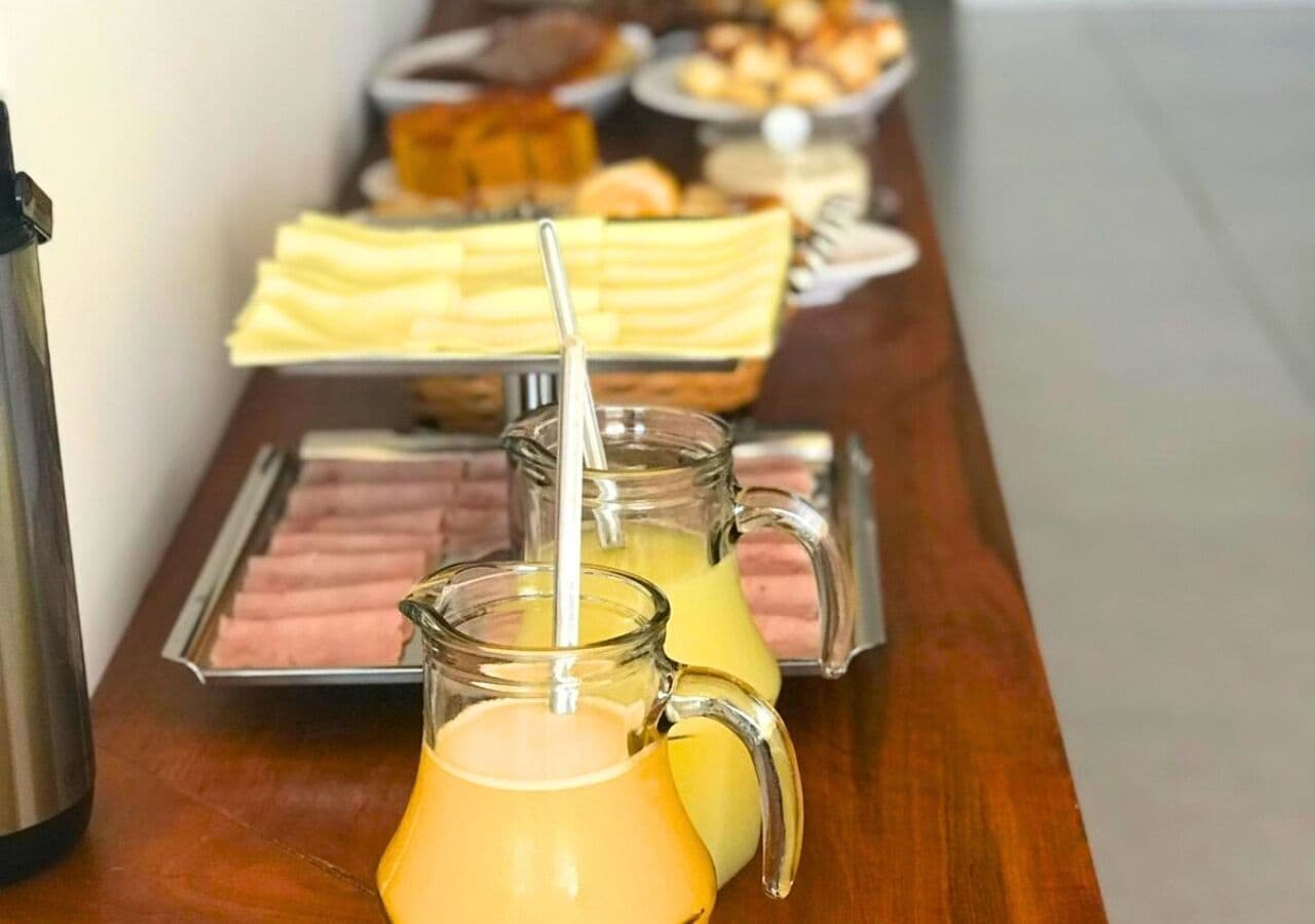 A buffet table with various food items and beverages.