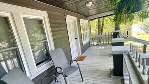 A covered porch with two chairs, a bench, and a small table. - NEW! Modern & Cozy close to Downtown Attractions! (Hot Springs)
