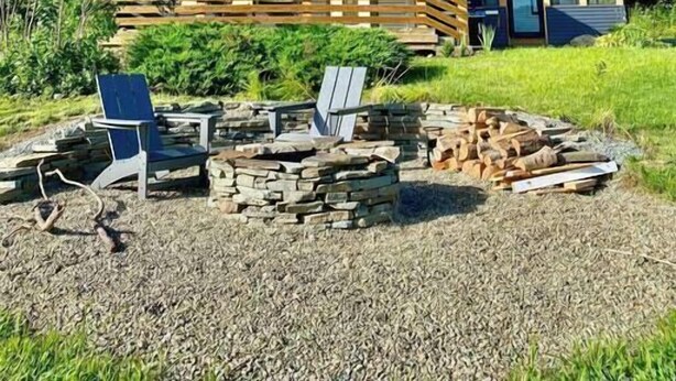 A two-story house with a deck and a fire pit area. - The Homestead - Walk to village, bring the pup! (Johnson)