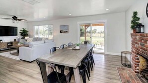 A spacious living area with a dining table, a sofa, and a fireplace. - Country Property, W&D, Open Concept, Pet Friendly (Loomis)