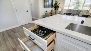 A modern kitchen with white cabinetry, a marble countertop, and a built-in sink. - Country Property, W&D, Open Concept, Pet Friendly (Loomis)