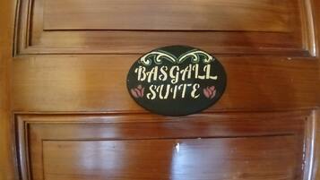 A wooden door with a sign that reads "Basgall Suite".