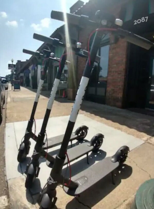 A stationary electric scooter parked on a sidewalk. - Stunning Memphis` Neighborhood-Guest House Retreat (Memphis)