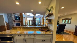 A kitchen with granite countertops, stainless steel appliances, and a large island.