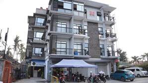 A multi-story hotel with balconies, a covered entrance, and a visible sign for 'Arte Hotel'. - QUEEN SUITE ROOM R#4 (Sogod, Southern Leyte)