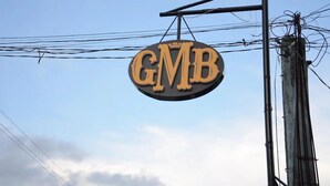 A hanging sign with the letters "GMB" against a clear sky. - QUEEN SUITE ROOM R#4 (Sogod, Southern Leyte)