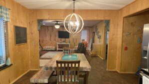A wooden interior with a dining table, chairs, a ceiling fan, and a refrigerator. - fishing ~ plenty of parking ~ 1/2 mile to marina ~ 5 min to new WestBay casino (Mead)